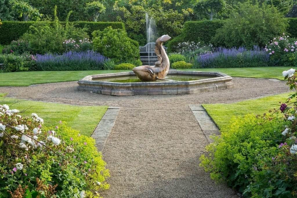 Coade-stone whale and mermaid fountain sculpted by Phillip Thomason in the rose garden at Farleigh Wallop