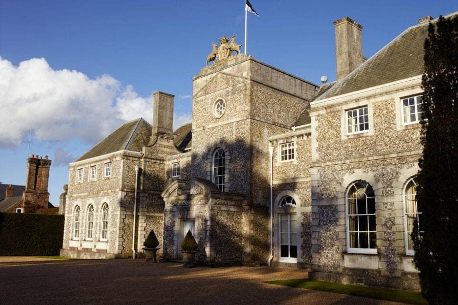 Farleigh House front facade with flag flying