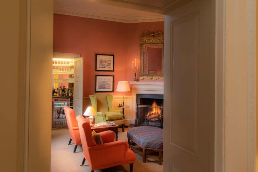 Cosy seating around a fireplace at Farleigh House